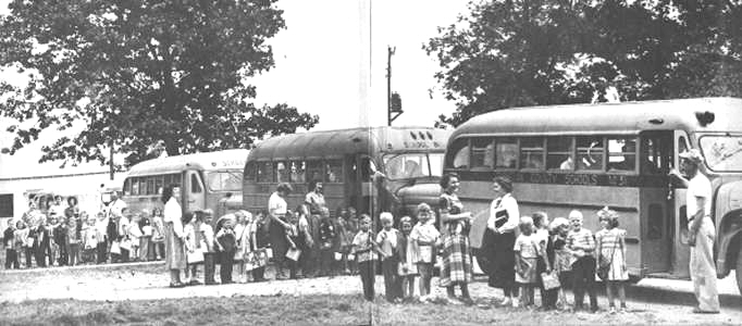 Students boarding buses (1950)